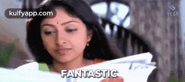 a woman is holding a piece of paper and says fantastic .