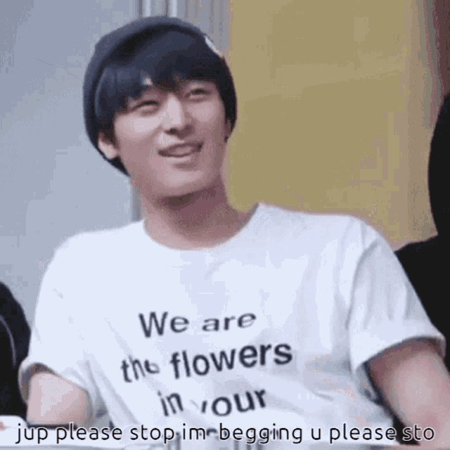 a man wearing a white shirt that says we are the flowers in your jup please stop im begging u please sto