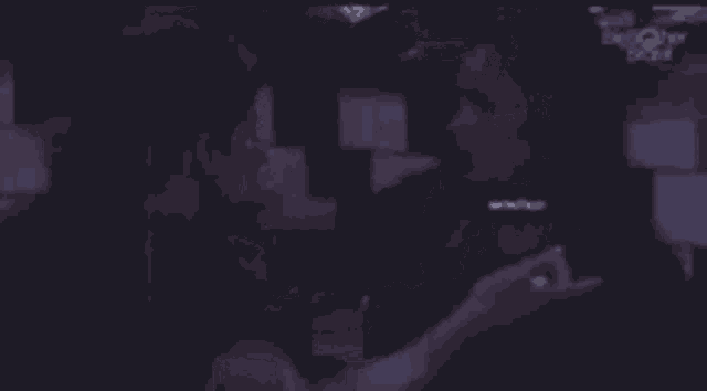 a blurry picture of a person holding a cigarette in their hand .