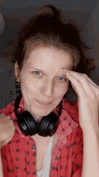 a woman wearing headphones and a red shirt with the letter n on it
