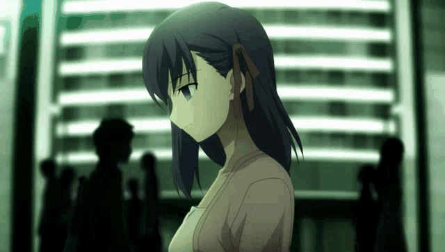 a girl with dark hair and blue eyes is standing in front of a building