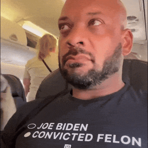 a man wearing a shirt that says joe biden convicted felon on it