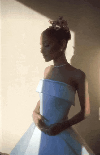 a woman in a white dress with a bun on her head