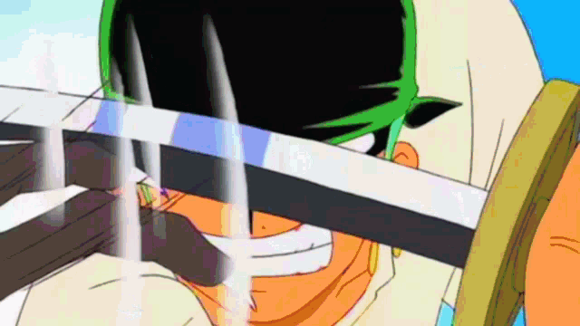 a close up of a cartoon character holding a sword in front of his face .