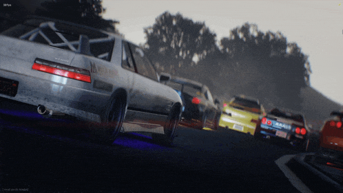 a screenshot of a video game shows a few cars driving down a road with a few trees in the background