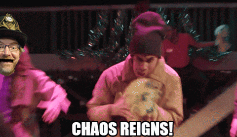 a group of people are dancing with the words chaos reigns in the corner