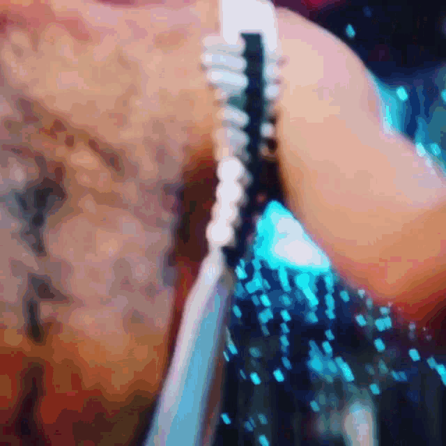 a close up of a person holding a microphone with a blurred background