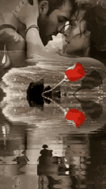 a man and a woman are kissing in the water with roses floating in the water .