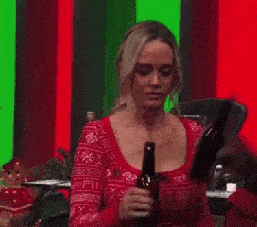 a woman standing in front of a christmas tree