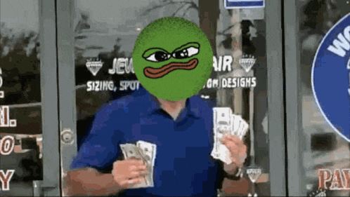 a man in a blue shirt has a green frog face on his face