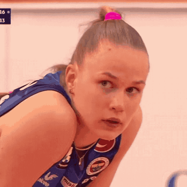 a girl wearing a blue shirt with the number 13 on it