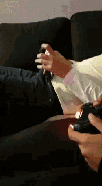a person is playing a video game with a controller
