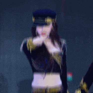 a woman wearing a hat and a crop top is pointing at the camera