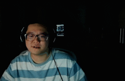 a blurry image of a man wearing headphones and glasses