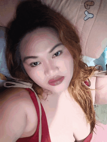 a woman in a red bra takes a selfie