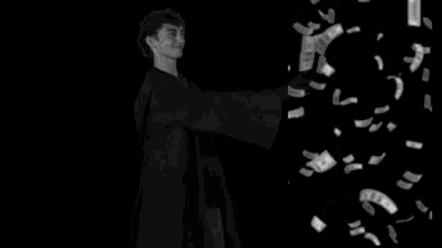 a man in a robe is standing in front of a pile of money