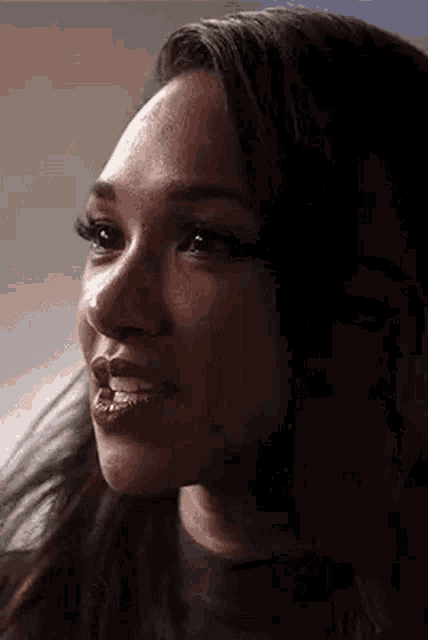a close up of a woman 's face with her eyes closed and her mouth open .