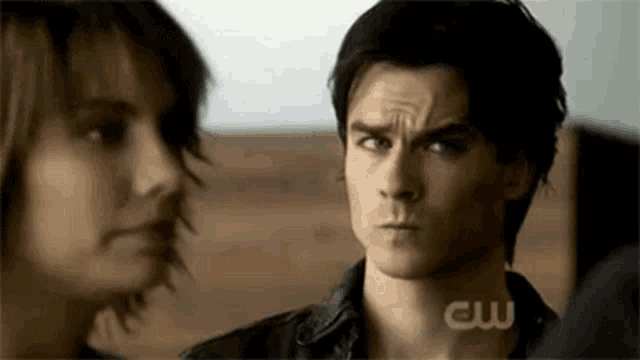 a man and a woman are looking at each other .