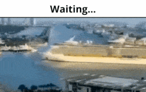 a large ship is docked in a harbor with the words " waiting " below it