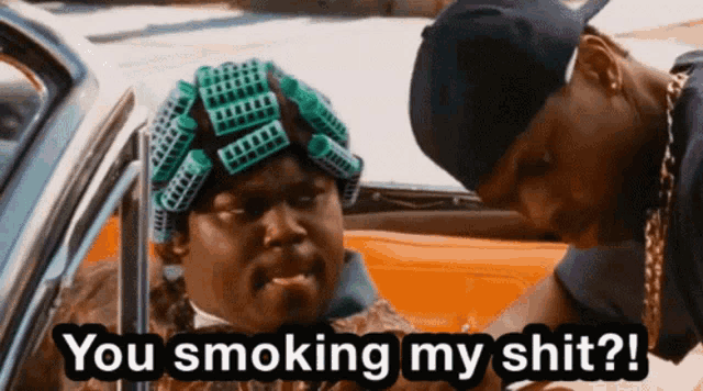 a man with curlers on his head says " you smoking my shit ? "