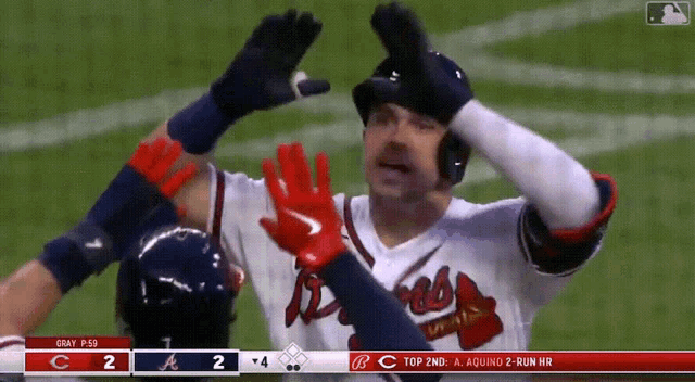 a baseball player wearing nike gloves celebrates a hit