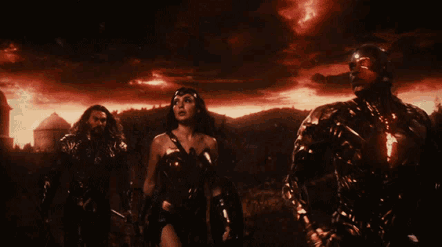 wonder woman and cyborg are standing next to each other in a dark landscape