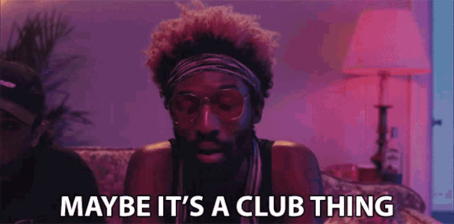 a man wearing sunglasses and a headband is saying maybe it 's a club thing