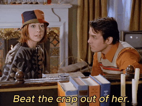 a man and a woman are sitting in front of a fireplace with the words beat the crap out of her below them