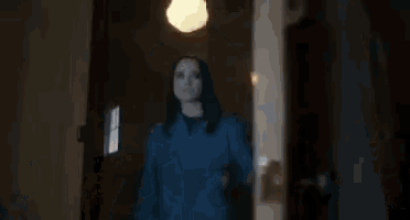 a man and a woman are sitting on a bed in a dark room .