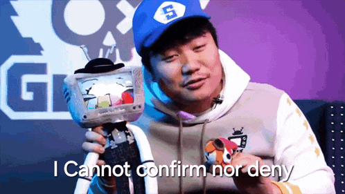 a man wearing a hat with the letter s on it is holding a stuffed animal and says i cannot confirm nor deny