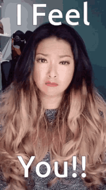 a woman with long hair is making a funny face and says " i feel you "