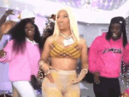 a group of people are dancing in a room with a woman in a crop top