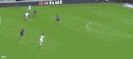 a soccer player with the number 21 on his jersey is kicking a ball