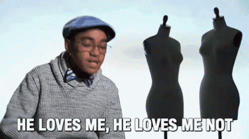 a man is standing in front of three mannequins and says he loves me he loves me not