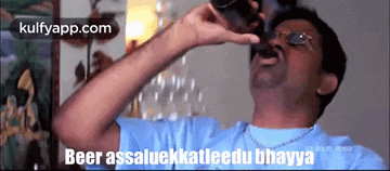 a man is drinking from a glass with the words beer assaluckkatleedu bhavya written below him