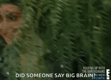 kim kardashian is smiling while standing in front of a tree .