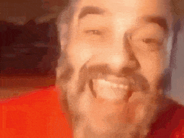 a man with a beard is making a funny face with his mouth open .