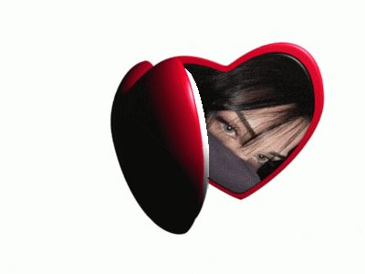 a red heart shaped mirror with a woman 's face visible
