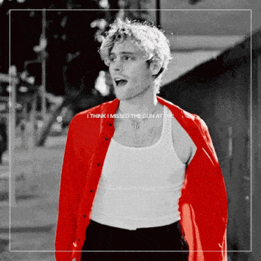a man wearing a red jacket and a white tank top with the words i think i missed the gun at the top