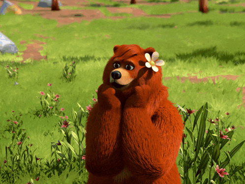 a brown bear with a flower in its hair is standing in the grass