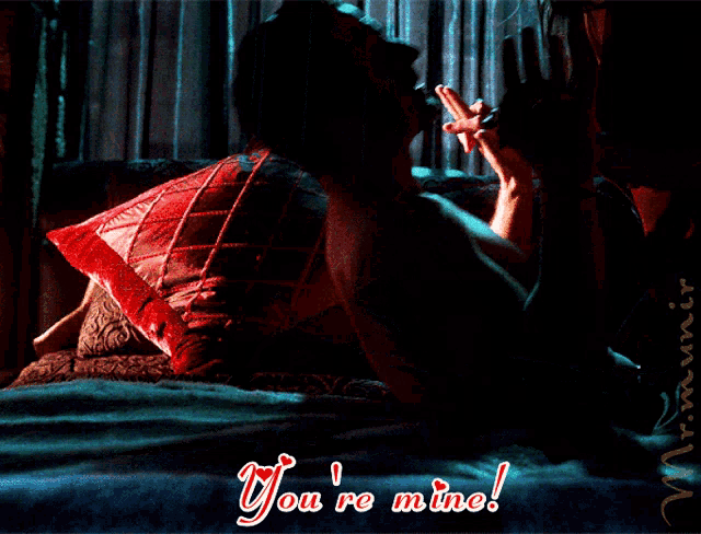 a man laying on a bed with the words you 're mine written on the bottom