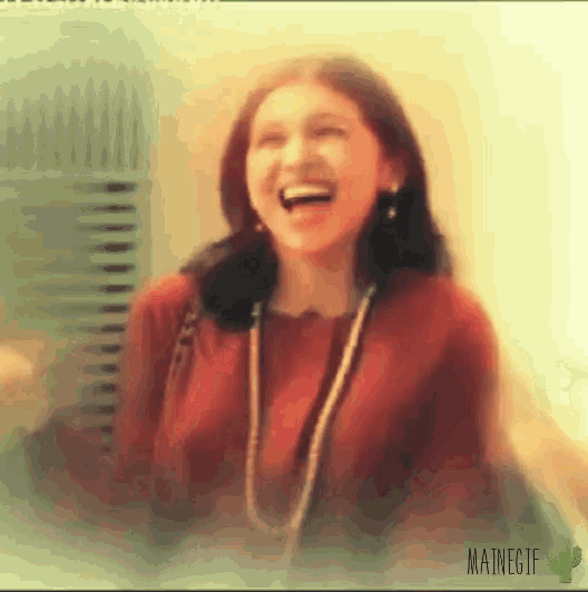 a blurry photo of a woman laughing with mainegif written on the bottom