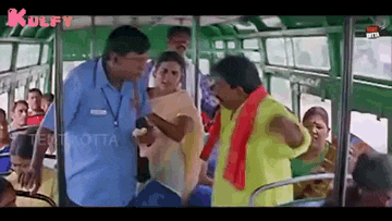 a man in a yellow shirt is talking to another man on a bus