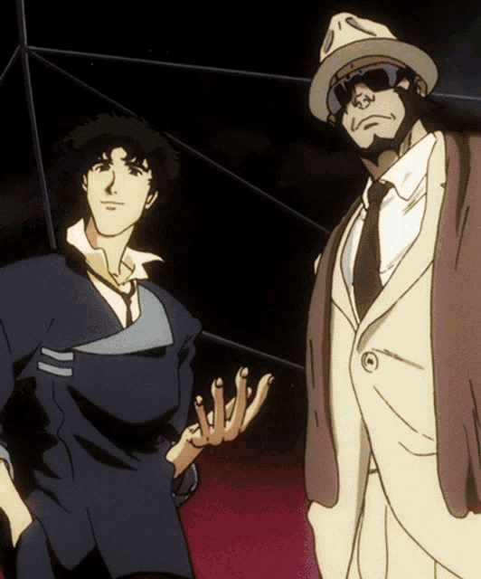 a man in a suit and hat stands next to another man