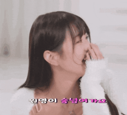 a woman covering her mouth with her hand with a foreign language written on it