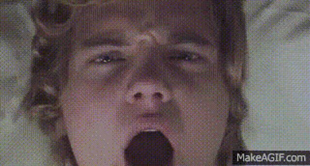 a close up of a person yawning with their mouth open