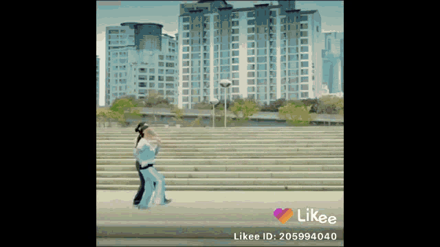 a likee video of a couple dancing on steps