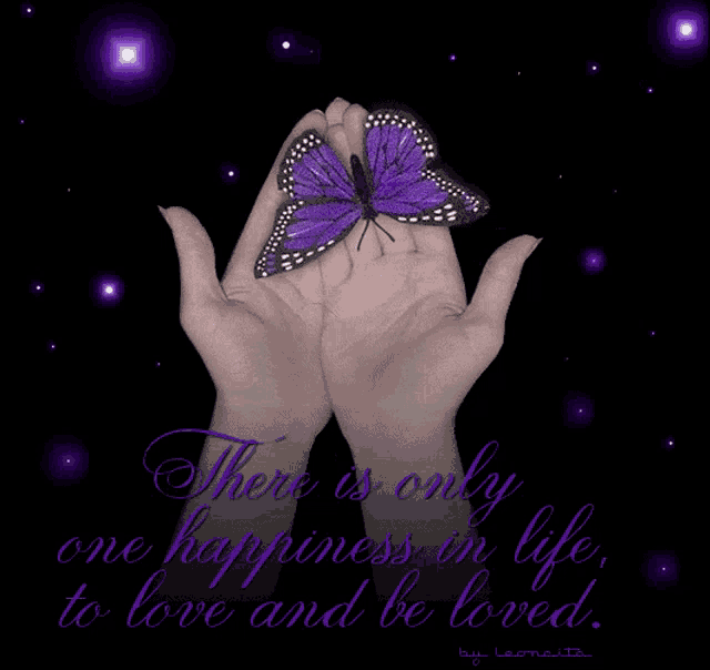 a purple butterfly is held in a woman 's hands