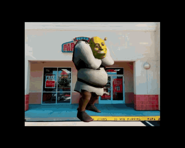 shrek standing in front of a papa john 's pizza restaurant