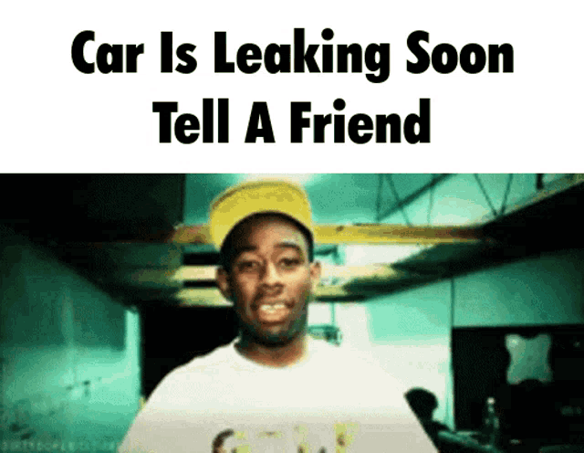 a man in a yellow hat is standing in front of a sign that says " car is leaking soon tell a friend "